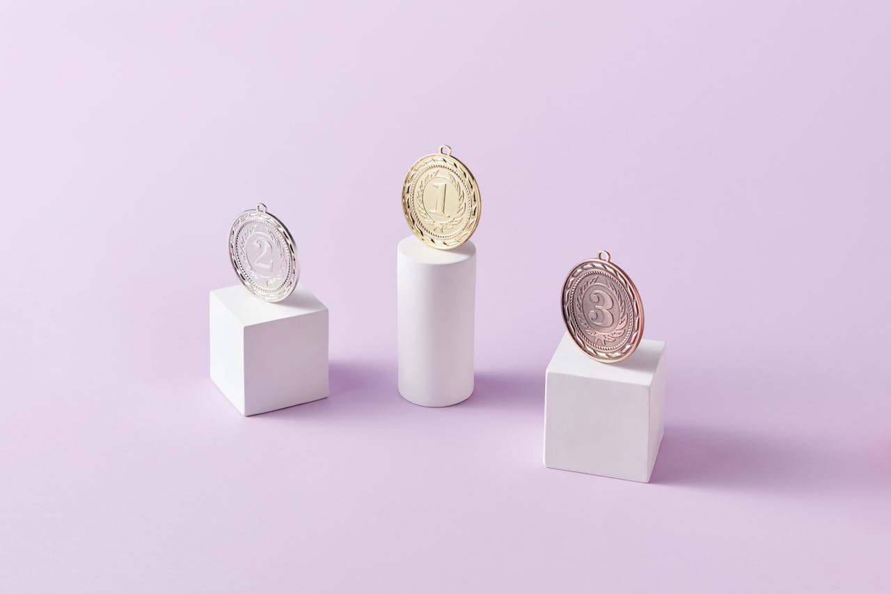 Three medals on podium blocks symbolizing first, second, and third place awards.